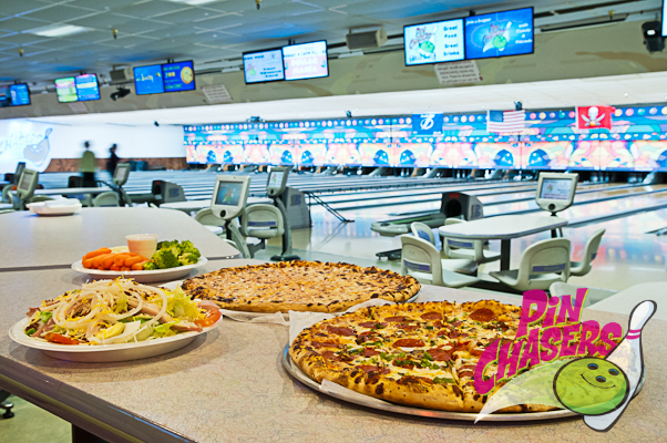 Pizza and food served to couple on date at bowling alley