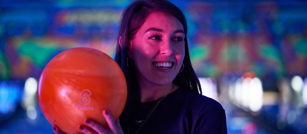 Woman enjoying cyber bowling night in Tampa
