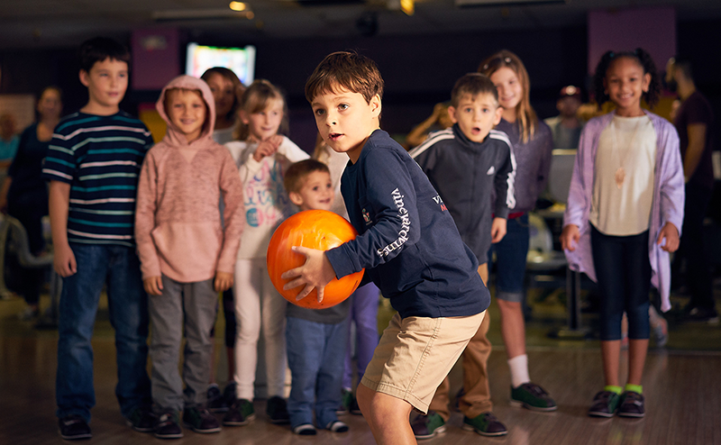 Young boy about to bowl a strike at Pin Chasers in Tampa