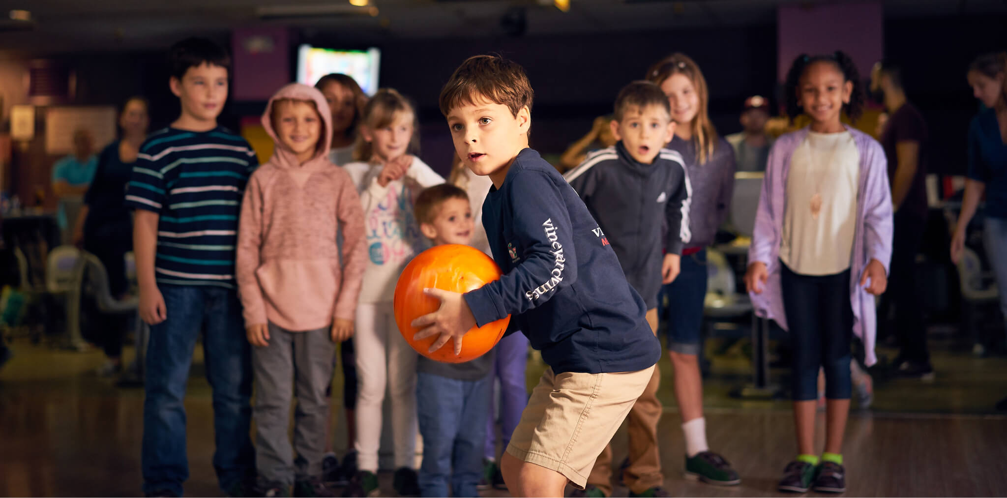 Young boy about to bowl a strike at Pin Chasers in Tampa