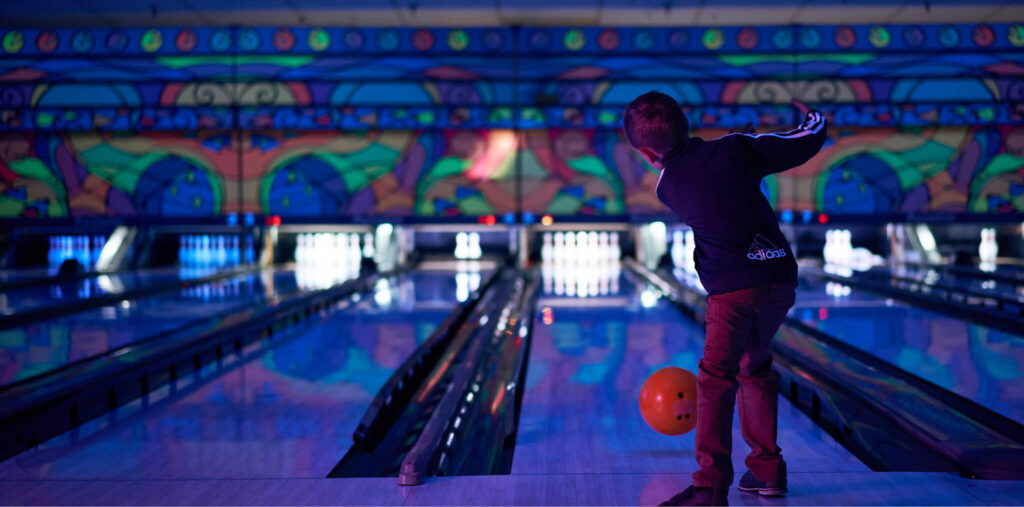 a child throwing a bowling ball